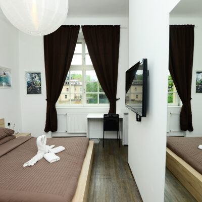 Double Room at Galeria Rooms - a cosy bedroom with a comfortable bed, a sleek TV and mirror, and a large window.